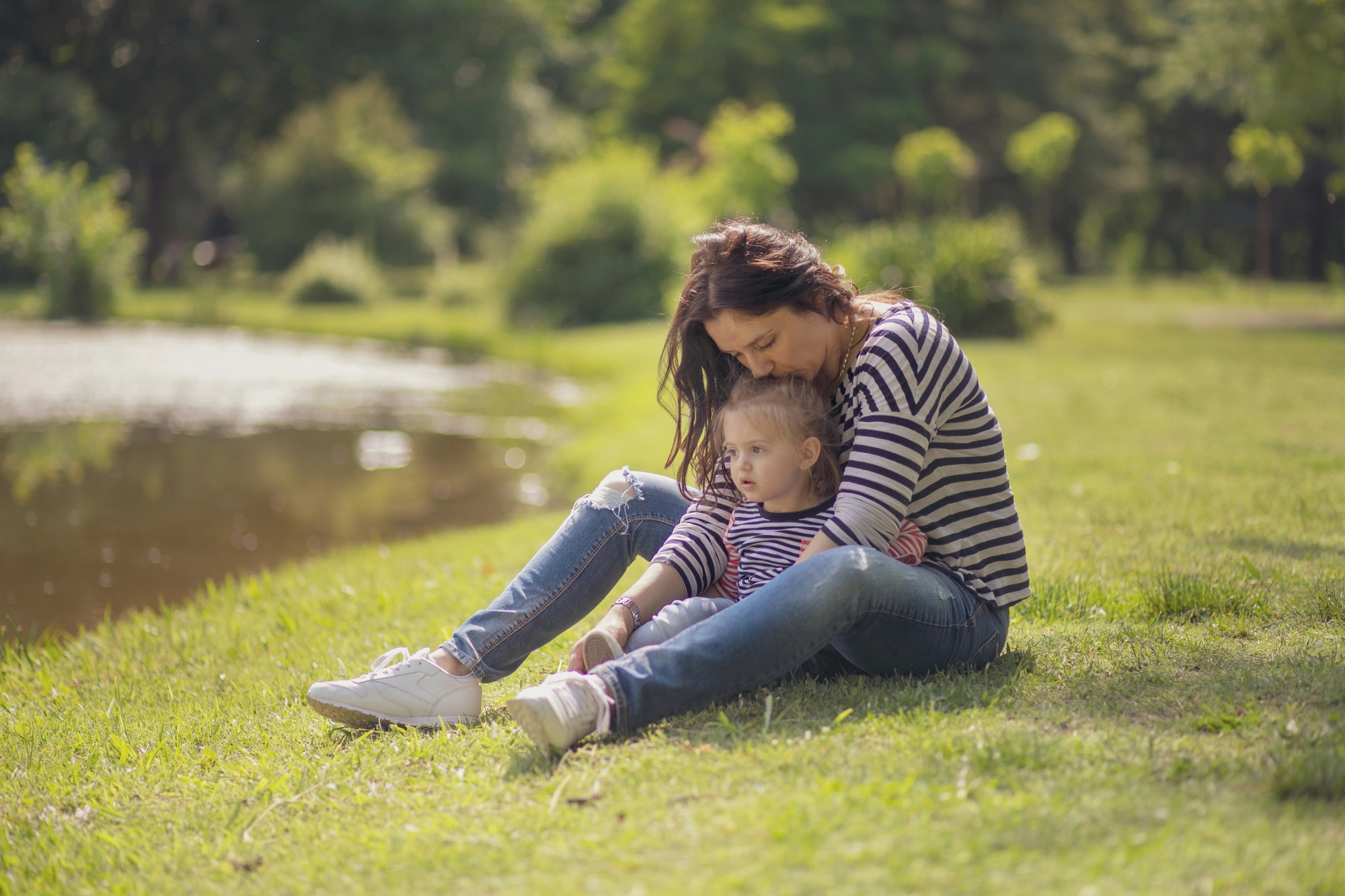 Happy mother and daughter enjoying outdoor family time in park